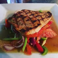 <p>Grilled Salmon over salad from Benvenutos.</p>