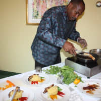 <p>Chef Wayne Theodis prepares his dish during the Iron Chef Showdown at Waveny LifeCare Network.</p>