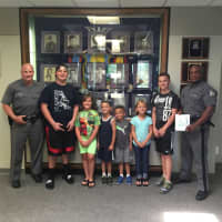 <p>Local children and teens show their appreciation for the State Police with a visit complete with a thank you card as part of the Blue Wave Shore to Shore effort.</p>