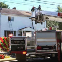<p>The Stratford Fire Department extinguishes the fire at 196-198 Larkin Court on Thursday.</p>