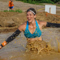 <p>Hart makes her way through the mud pit.</p>