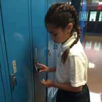 <p>Isabella Galan gets to know her locker code.</p>