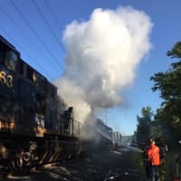 <p>Congers firefighters work to extinguish a fire aboard a CSX train.</p>