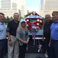 <p>HUMC officials deliver a wreath to the Freedom Tower on the 16th Charity Run.</p>