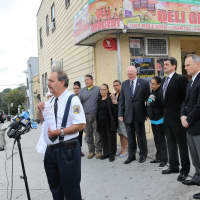 <p>Members of the New Rochelle Police Department with Manuel Ayala&#x27;s family outside of the bodega he was shot at last year.</p>