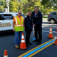 <p>Rochelle Park Police Chief Robert Flannelly and Police Commissioner Jay Kovalcik joined DPW laborer Roy Spraguer in paint the township&#x27;s thin blue line.</p>