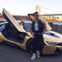 <p>Persin and his gold chrome BMW i8.</p>