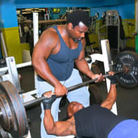 <p>Club F.I.T friends help each other in the weight room.</p>