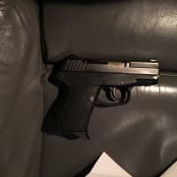 <p>Police found a 9mm handgun concealed just below the steering column in the car.</p>