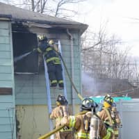 <p>Central Nyack firefighters work to extinguish a fire a garbage-filled home on Waldron Avenue.</p>