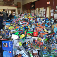 <p>Helpers and officers alike sorted through the mountains of toys in no time.</p>