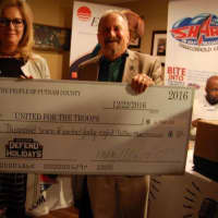 <p>Jim Rathschmidt accepts a check from Putnam County Executive MaryEllen Odell at a recent fund-raising for United for the Troops.</p>