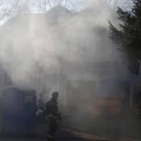 <p>A burning dumpster produces a lot of smoke Wednesday on Westfair Drive in Westport.</p>