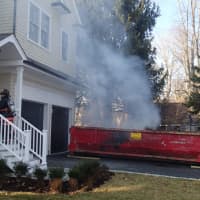 <p>A burning dumpster is very close to a  residence on Westfair Drive in Westport on Wednesday afternoon.</p>