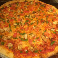 <p>Pollo Pesto pizza made with roasted chicken, tomato, mozzarella cheese and pesto from Sauro&#x27;s Town Square Pizza Cafe in Patterson.</p>