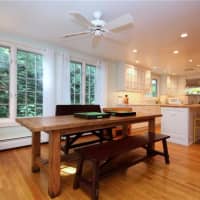 <p>The open kitchen features marble countertops and updated amenities.</p>