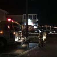 <p>Firefighters filling up E-2 in front of the Wire Mill Saloon and Barbecue in Georgetown on Sunday night.</p>