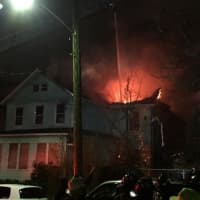 <p>Firefighters battled a two-alarm blaze that destroyed a Mount Vernon home displacing a dozen people overnight.</p>