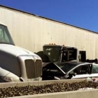 <p>The tractor-trailer was removed but two vehicles remained at the scene awaiting tow trucks as of 4 p.m., police said.</p>