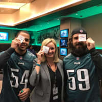 <p>Jessica Spingler of Oakland sports a LoveFromLiam eye patch with Philadelphia Eagles players Kamu Grugier-Hill, left, and Joe Walker.</p>