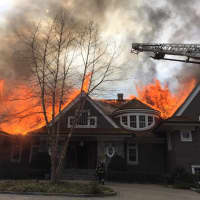 <p>Greenwich firefighters attack a large blaze in the home at 45 Londonderry Drive in Greenwich on Saturday afternoon.</p>