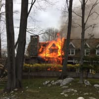 <p>A fire is burning through the roof of the home at 45 Londonderry Drive in Greenwich on Saturday afternoon.</p>