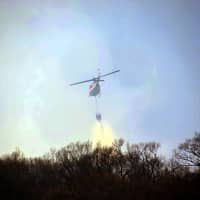 <p>Helos dumped water while firefighters worked the perimeter.</p>