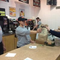 <p>The Bagelman &quot;hand-off&quot; to a hungry customer.</p>
