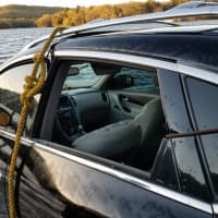 <p>Cables are affixed on the car to pull it out of Lake Zoar.</p>