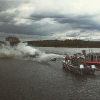 <p>Stratford first-responders help extinguish a boat fire on Tuesday on the Housatonic River.</p>