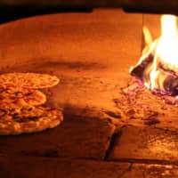 <p>Martio&#x27;s famous pizza sizzling in the brick oven.</p>