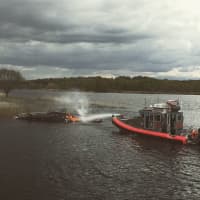 <p>Stratford first-responders help extinguish a boat fire on Tuesday on the Housatonic River.Stratford Professional Firefighters</p>