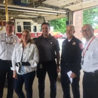 <p>Devon Walsh with some of the responders who helped pull her from her vehicle.</p>