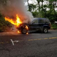 <p>Stony Hill firefighters battles this car blaze on Tuesday.</p>