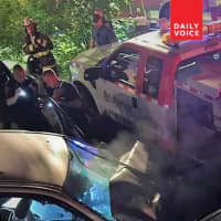 <p>Firefighters cut the driver from her car.</p>