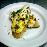 <p>Homemade whipped ricotta mase with local organic milk, toasted walnuts, saffron-infused honey and backyard mint, on grilled house made bread.from Aesop&#x27;s Fable in Chappaqua.</p>