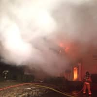 <p>Firefighters from multiple departments assisted in fighting the fire on Shadow Lane in Wilton on Thursday.</p>