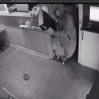 <p>The suspect in the burglary of Rowayton Pizza grabs the cash register and flees.</p>