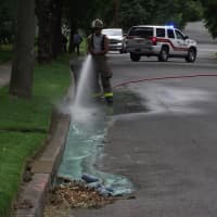 <p>Firefighters clear paint from a Glen Rock street.</p>