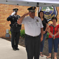 <p>Haverstraw Police Chief Charles Miller gives a final salute before his retirement on June 23.</p>