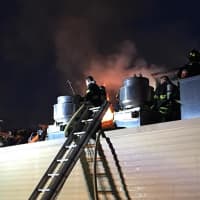 <p>Firefighters braved flames blowing through the roof.</p>