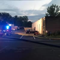 <p>Crews from Bethel and Stony Hill fire departments tackle a blaze early Saturday in a commercial building on Diamond Street.</p>