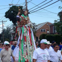 <p>Money is pinned to the St. Rocco statue during the procession.</p>