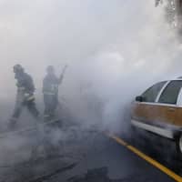 <p>Crews from the Westport Fire Department battled a blaze that broke out in the front end of a station wagon.</p>