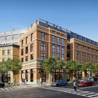 <p>The new 2.5-acre development comprises two mid-rise brick buildings that include office space, retail stores, apartment rentals and parking -- along with 12,000-square-feet of public outdoor space.</p>