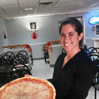 <p>Jenna Throne of Saddle Brook brings out a pie for customers.</p>
