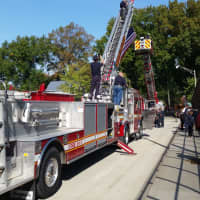 <p>Teaneck and Ridgefield Park fire departments linked their ladder trucks in tribute.</p>