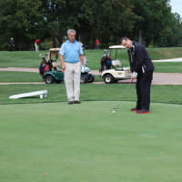 <p>A player watches his playing partner putt during the 21st Annual Golf Classic to benefit the Wyckoff Family YMCA.</p>