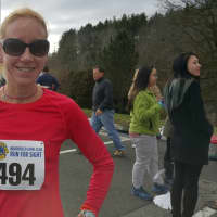 <p>Sara Belles of Brookfield posts the fastest time among female runners in the New Year’s Day Brookfield Lions Run for Sight 4-mile race on Friday.</p>