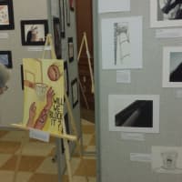 <p>A visitor enjoys some of the more than 100 pieces of art on display Monday during Port Chester High School&#x27;s second annual IB Visual Arts show.</p>